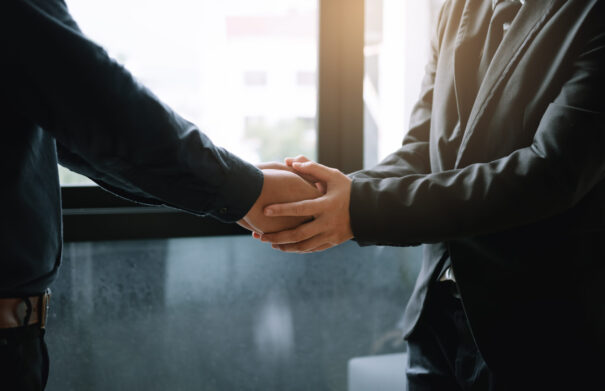 Business people holding hands together for support empathy work together.